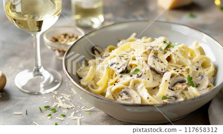 Indulge in a gourmet presentation of Fettuccine pasta, elegantly tossed in a luxurious truffle cream sauce and combined with a variety of mixed mushrooms, including oyster and portobello 117658312