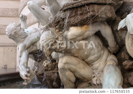 Plastic pose and dramatic expression in this fountain at the entrance of Palace Hoffburg, Wien 117658535