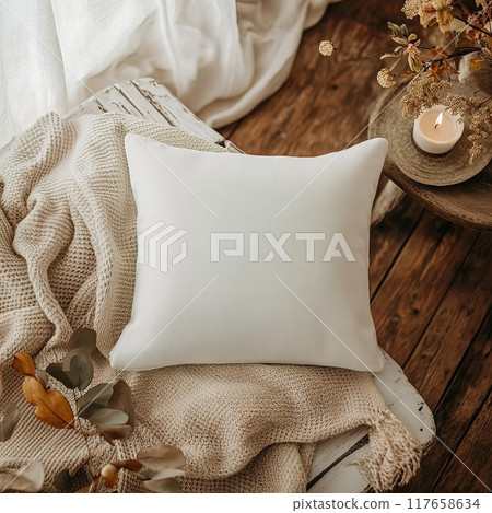 A Cozy White Pillow Laid Comfortably on a Soft Textured Blanket Enhancing the Ambiance White Square Pillow Mockup 117658634