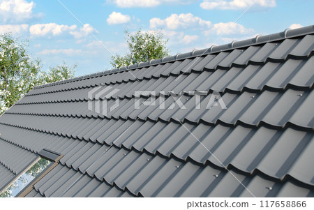 Close-up house roof with steel roofing sheet. Gray modular tile effect roof panel. Traditional metal shingle tiles. Profiled metallic corrugated pantile as clay or concrete slate. Building's covering 117658866