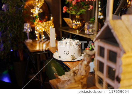 White wedding cake decorated with chocolate flowers and blueberries White wedding cake decorated with chocolate flowers and blueberries 117659094