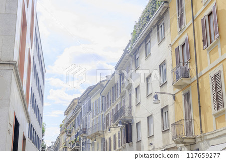Italian pastel-colored building walls shining against the blue sky 117659277
