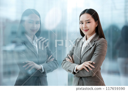 A woman in a business suit is posing for a picture A woman in a business suit is posing for a picture 117659390