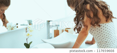 Stressed young woman in bathroom 117659608
