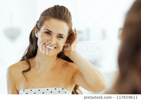 happy young woman in bathroom 117659611