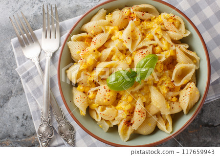Creamy corn pasta features a silky sauce made from corn as well as pops of juicy kernels for texture closeup in the bowl. Horizontal top view Creamy corn pasta features a silky sauce made from corn as well as pops of juicy kernels for texture closeup in the bowl. Horizontal top view 117659943