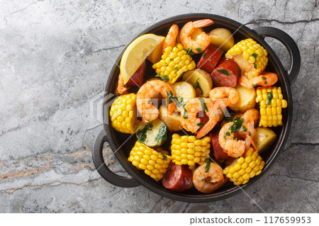Homemade Cajun Seafood Boil with shrimp, corn, baby potatoes, sausage and lemons closeup. Horizontal top view Homemade Cajun Seafood Boil with shrimp, corn, baby potatoes, sausage and lemons closeup. Horizontal top view 117659953
