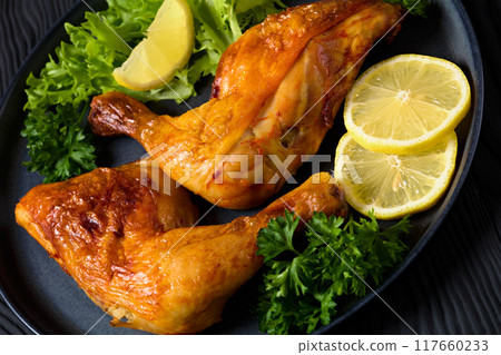 fried chicken legs with lettuce, lemon on plate fried chicken legs with lettuce, lemon on plate 117660233