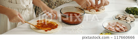 Family Cooking Pizza Together In The Kitchen Family Cooking Pizza Together In The Kitchen 117660666