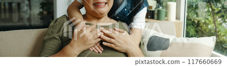 Granddaughter Embracing Her Grandma At Home Granddaughter Embracing Her Grandma At Home 117660669