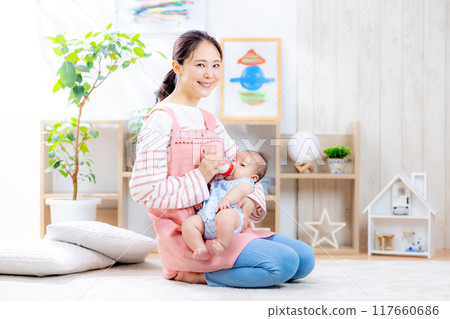 Mom holding baby, giving milk 117660686