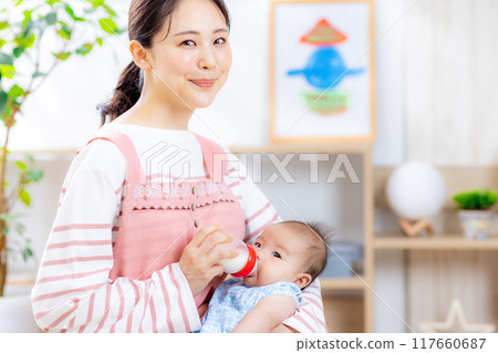 Mom holding baby, giving milk 117660687