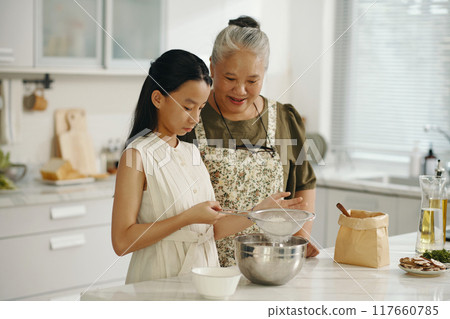 Girl Learning To Bake Cake With Grandma Girl Learning To Bake Cake With Grandma 117660785