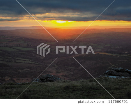 Sunset from Brats Tor over north Devon, Brent Tor in the distance, Dartmoor UK Sunset from Brats Tor over north Devon, Brent Tor in the distance, Dartmoor UK 117660791