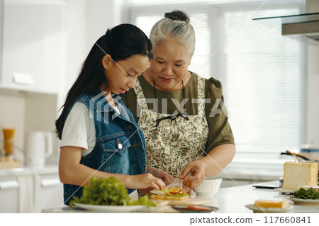 Girl Cooking Sandwich With Grandma Girl Cooking Sandwich With Grandma 117660841