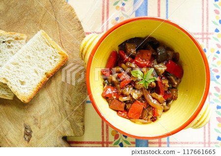 Italian traditional Sicilian dish, Caponata, stewed summer vegetables with tomatoes, aerial view 117661665