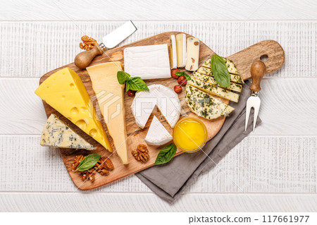 An assortment of various cheeses arranged on a board, highlighting different textures An assortment of various cheeses arranged on a board, highlighting different textures 117661977