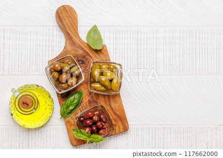 An assortment of various olives presented in a bowl, showcasing different colors, textures, and flavors An assortment of various olives presented in a bowl, showcasing different colors, textures, and flavors 117662000