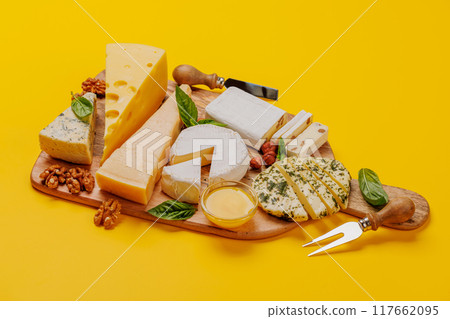An assortment of various cheeses arranged on a board, highlighting different textures An assortment of various cheeses arranged on a board, highlighting different textures 117662095