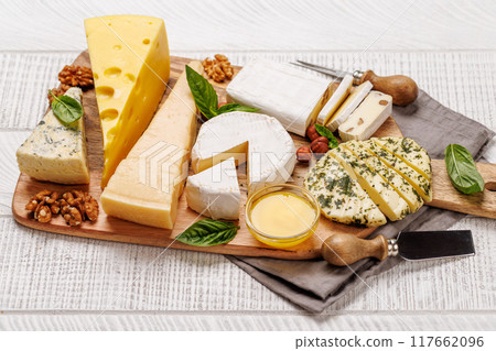 An assortment of various cheeses arranged on a board, highlighting different textures An assortment of various cheeses arranged on a board, highlighting different textures 117662096