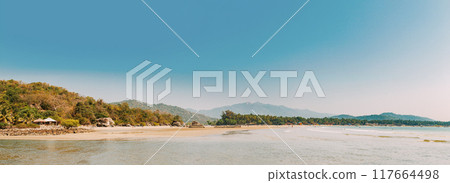 Canacona, Goa, India. Sunny Sky Over Calm Water Of Arabian Sea. Natural Landscape With Sandy Palolem Beach At Sunny Summer Day With Blue Sky Canacona, Goa, India. Sunny Sky Over Calm Water Of Arabian Sea. Natural Landscape With Sandy Palolem Beach At Sunny Summer Day With Blue Sky 117664498