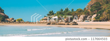 Canacona, Goa, India. Sunny Sky Over Calm Water Of Arabian Sea. Natural Landscape With Sandy Palolem Beach At Sunny Summer Day With Blue Sky Canacona, Goa, India. Sunny Sky Over Calm Water Of Arabian Sea. Natural Landscape With Sandy Palolem Beach At Sunny Summer Day With Blue Sky 117664503