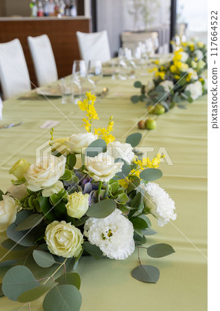 Table decorations at a party venue using green apples 117664522