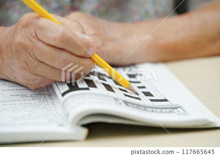 Bangkok, Thailand - May 15, 2022 elderly woman playing sudoku puzzle game. 117665645