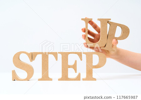 Wooden alphabet blocks arranged with the word "STEP UP" Wooden alphabet blocks arranged with the word "STEP UP" 117665987