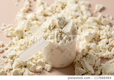 Protein powder. Vanilla flavour of protein powder in scoop, closeup. 117666464