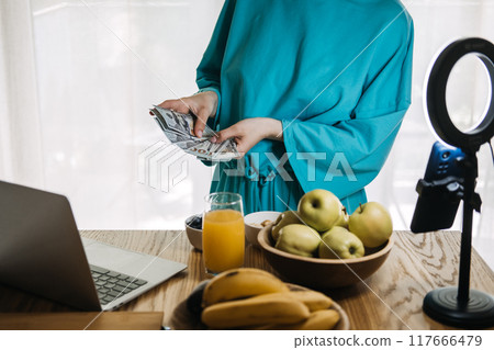 Content creator counting money during live stream, influencer marketing, financial success, digital entrepreneurship, online earnings, social media revenue 117666479