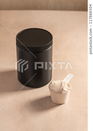 Protein powder in a measuring scoop. Nutrition and food supplement 117666504