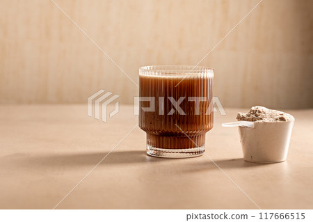 Chocolate protein powder in a measuring scoop. Nutrition and food supplement 117666515