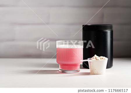 Collagen pink powder. Protein powder in a scoop. Food supplement 117666517