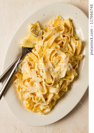 Fettuccine, tagliatelle, in creamy garlic sauce, Italian traditional cuisine, pasta carbonaro, 117666748