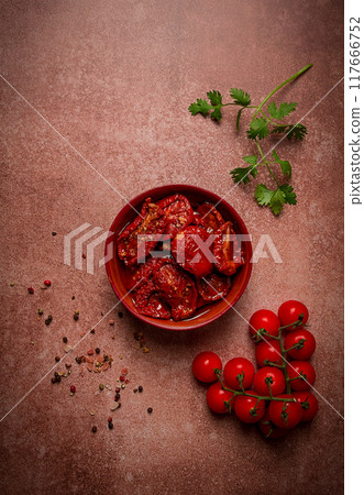 dried tomatoes, in a bowl, top view, on a brown background, dried tomatoes, in a bowl, top view, on a brown background, 117666752