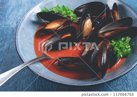 Fra Diavolo mussels, mussels in tomato sauce, Italian dish, on a blue background, homemade, no people, 117666768