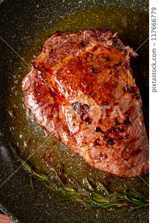 fried steak, beef steak, rib eye steak, in a frying pan, top view, no people 117666779