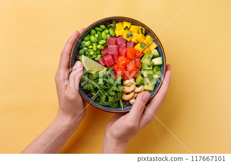 Top view of a colorful salmon poke bowl with fresh vegetables and rice, presented Top view of a colorful salmon poke bowl with fresh vegetables and rice, presented 117667101