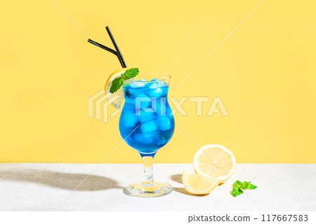 Blue Lagoon Cocktail on yellow Blue Lagoon Cocktail on yellow 117667583