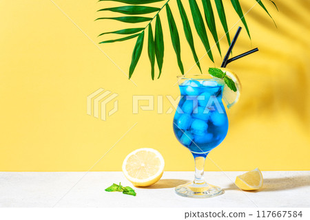Blue Lagoon Cocktail on yellow Blue Lagoon Cocktail on yellow 117667584