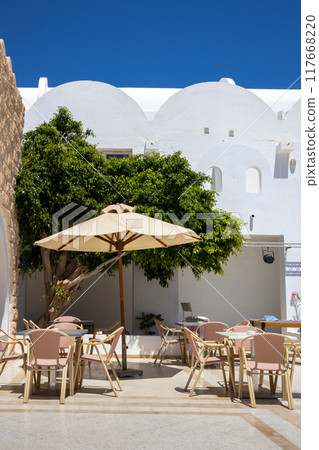 Patio of a hotel with chairs and sun umbrella, Djerba, Tunisia 117668220