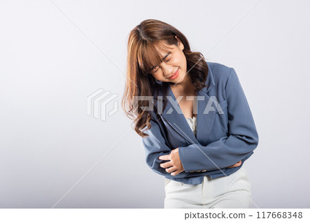 Portrait of Asian beautiful young woman has stomachache, female abdominal pain suffering from stomach ache, studio shot isolated on white background, period pain, Health and medical gastritis concept 117668348