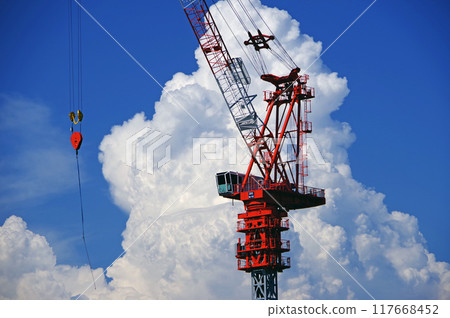Summer cumulonimbus clouds and tower cranes 117668452