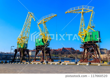 Old cranes on city boulevard in Szczecin, Poland Old cranes on city boulevard in Szczecin, Poland 117668520