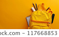 Yellow school bag with copyspace for template. Backpack and accessories. Back to school concept. Orange schoolbag with empty background 117668853