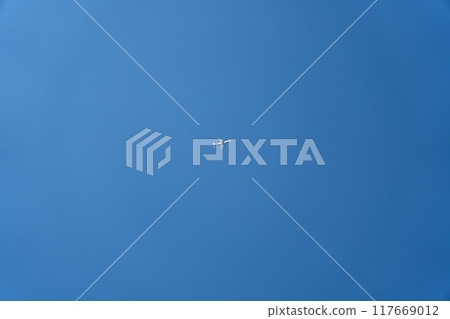 A passenger plane is flying far in the sky. Minimalism 117669012
