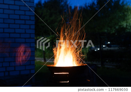 The fire is burning in the grill. A bonfire burning at night 117669030