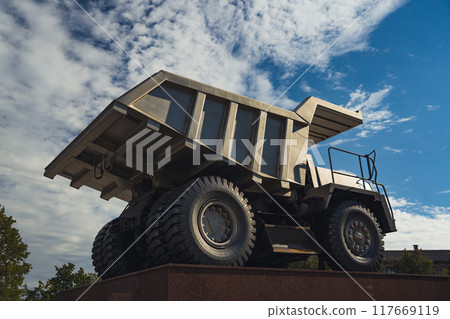 A statue of a huge, quarry dump truck in the city 117669119