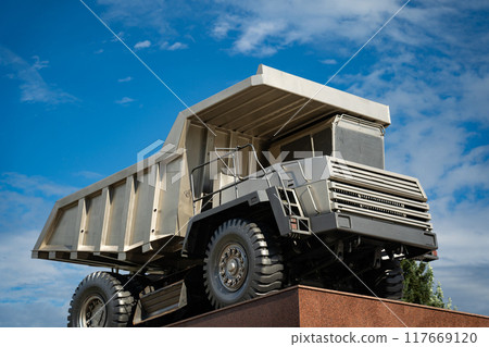 A statue of a huge, quarry dump truck in the city 117669120